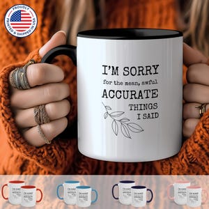 May include: White ceramic coffee mug with a black rim and handle. The mug has a funny saying printed on it: "I'm sorry for the mean, awful accurate things I said".