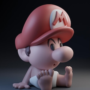 May include: A red and white baby Mario figurine wearing a red cap with a white 'M' on it. The figurine is sitting with its legs crossed and its hands on its lap.