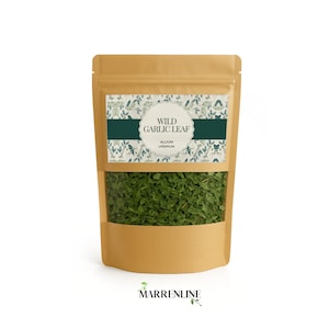 May include: A tan stand-up pouch containing dried green wild garlic leaves. The label features a botanical pattern, a central white scalloped frame, and the text: WILD GARLIC LEAF ALLIUM URSINUM. The brand name MARRENLINE is printed below the pouch.