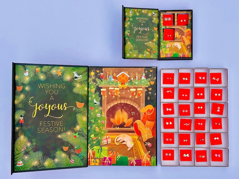 a festive holiday-themed box with a card and earrings, as well as a set of red boxes with earrings inside.