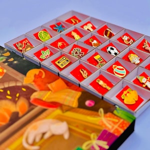 A collection of colorful pin badges displayed in a box, with a blurred background that appears to be a Christmas-themed illustration.