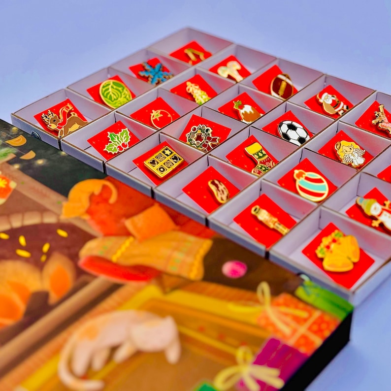A collection of colorful pin badges displayed in a box, with a blurred background that appears to be a Christmas-themed illustration.