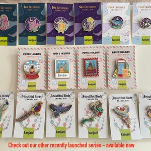 a collection of pins and badges featuring various sea creatures, including sea birds, sea creatures, and other marine life. The pins and badges are arranged in rows, showcasing the different designs and styles of the items.