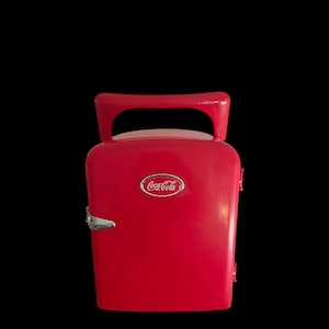 May include: A red mini fridge with a Coca-Cola logo on the front. The fridge has a silver handle and a silver latch.