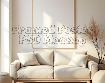 May include: A framed poster mockup with the text "Framed Poster PSD Mockup" displayed above a cream-colored sofa with pillows. The room has a neutral color palette, with a large window and decorative plants.