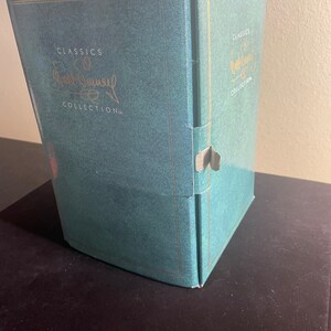 May include: A teal blue box with gold trim and the text "Classics of Walt Disney Collection" on the front.