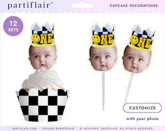 May include: Set of 12 cupcake toppers featuring a black and white checkered crown with the word "ONE" in yellow letters and a smiley face. The toppers are designed to be customized with a photo of a baby.