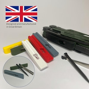 May include: A multi-tool with a green handle and various attachments, alongside several colored, rectangular tools. The tools are yellow, green, white, red, and gray. The image also includes a small inset showing additional tools and the text "Designed and manufactured in Great Britain."