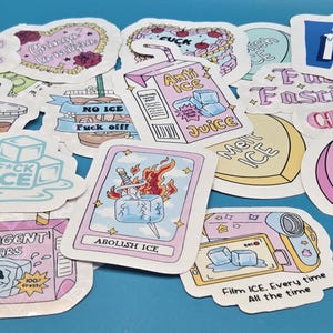 Set of 19 pastel anti-ICE protest stickers with bold activist slogans and playful illustrations. Designs include “Abolish ICE,” “Fight Fascism,” “Chinga La Migra,” “Anti ICE Juice” carton, melting ice cubes, tarot-style card with flaming sword, iced coffee cup, “ICE Agent Tears” carton, camcorder graphic, and “Stay Hydrated to Fight Fascists.” Die-cut with white borders and glossy finish, shown on a blue background.