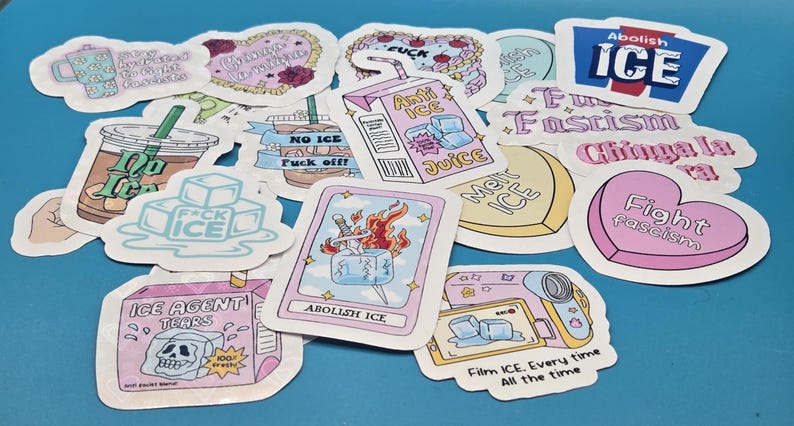 Set of 19 pastel anti-ICE protest stickers with bold activist slogans and playful illustrations. Designs include “Abolish ICE,” “Fight Fascism,” “Chinga La Migra,” “Anti ICE Juice” carton, melting ice cubes, tarot-style card with flaming sword, iced coffee cup, “ICE Agent Tears” carton, camcorder graphic, and “Stay Hydrated to Fight Fascists.” Die-cut with white borders and glossy finish, shown on a blue background.