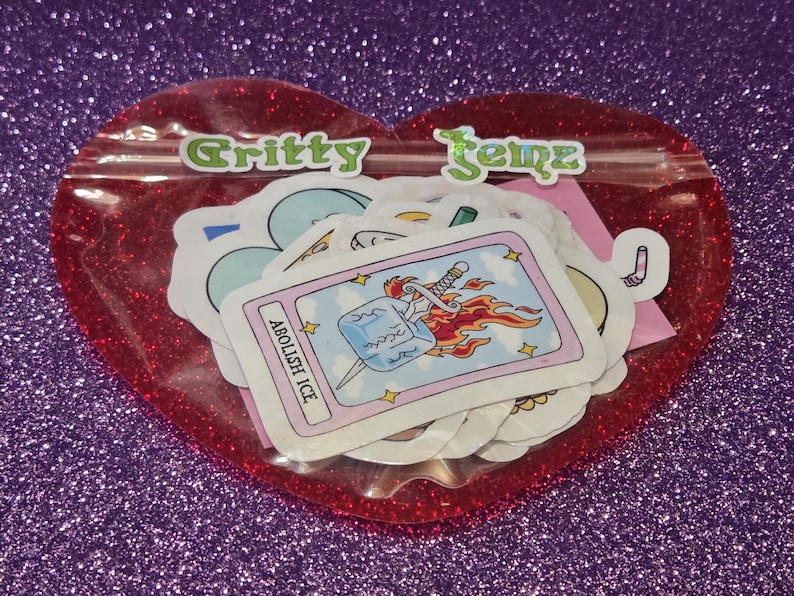 This sticker set comes packaged in a reusable, heart-shaped red glitter pouch with a clear front so you can see the designs inside. The pouch is securely sealed to keep the stickers protected during shipping. The vibrant, gift-ready packaging makes it perfect for storage, display, or easy gifting while keeping your stickers safe and organized.