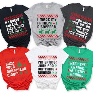 May include: Collection of Christmas-themed t-shirts in various colors, each with a humorous holiday message in white text. Designs include festive patterns, trees, and reindeer.