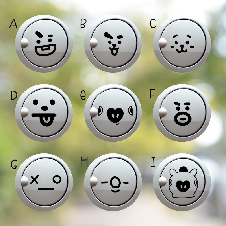May include: A set of nine circular white buttons, each featuring a distinct black graphic character face. The buttons are labeled A through I in black text. Each button has a small circular protrusion on the left side of the outer rim.