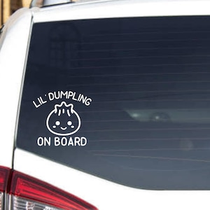May include: White car decal with a cartoon dumpling and the text "Lil' Dumpling On Board".