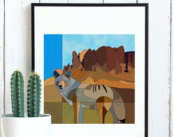 May include: A framed geometric illustration of a coyote in a desert landscape. The coyote is a light gray color with brown and tan accents. The background is a colorful abstract depiction of a desert scene with red, brown, and blue hues.
