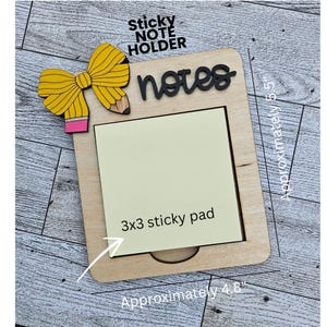 May include: Wooden sticky note holder with a yellow pencil bow accent. The holder has a rectangular shape, approximately 4.8 inches wide and 5.5 inches tall, and includes a 3x3 sticky pad. The words "sticky note holder" and "notes" are visible.