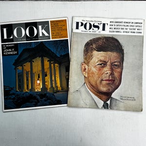 May include: Two vintage magazines side by side. The left is a Look magazine featuring the White House at night with the text In Memory of John F. Kennedy. The right is a Saturday Evening Post magazine with a portrait of John F. Kennedy by Norman Rockwell.
