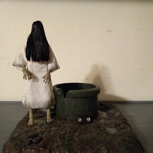 Custom Ringu Sadako fully poseable action figure with well and forest floor base.  Includes cursed tape.