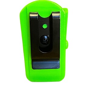 Puede incluir: Una luz de clip de color verde brillante con un clip negro y una peque&ntilde;a luz LED verde.