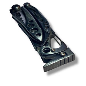 May include: A black multi-tool with a variety of tools, including a knife, pliers, and a screwdriver. The tool is closed and has a textured handle.