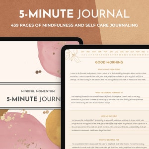 May include: A digital tablet displaying a pink and gold journal cover with the text "5-MINUTE JOURNAL" and "439 PAGES OF MINDFULNESS AND SELF CARE JOURNALING". The journal pages feature prompts for daily reflection, including "What I Want From Today", "What I'm Looking Forward To", "How My Day Went", and "What I'm Grateful For".