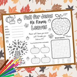 May include: A white activity sheet with fall-themed illustrations and text. The sheet includes a maze, word search, connect-the-dots, and pumpkin designs. Text reads "Fall for Jesus He Never Leaves" and a Bible verse. Colored pencils are in the lower left corner.