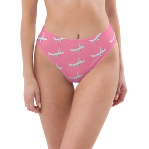 May include: Pink high-waisted bikini bottom with a white airplane print.