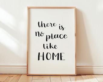 May include: A framed print with the text "there is no place like HOME" in black cursive lettering on a white background.