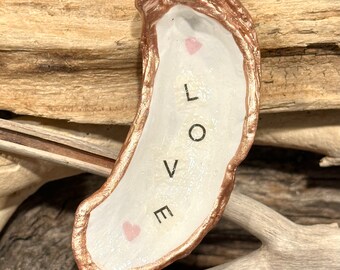 Decoupage love letters on a real, oyster shell, beach combed along Florida’s Atlantic coast.