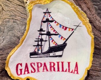 Decoupage + hand painted Gasparilla pirate ship on a beach combed oyster shell.  Perfect for year round Tampa decor. Stands add’l cost.