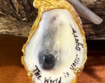 Real oyster shell, beach combed along the northern Outer Banks of NC with “The World is your Oyster” hand painted on it. *Large oyster*