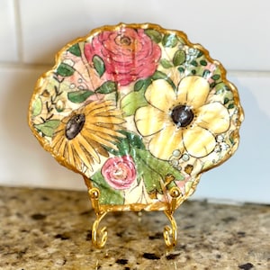 Decoupage floral pattern on a hand painted flat scallop shell.
