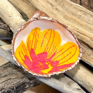 Decoupage yellow and pink Marimekko floral pattern on a real cockle shell, beach combed along Florida’s gulf coast.