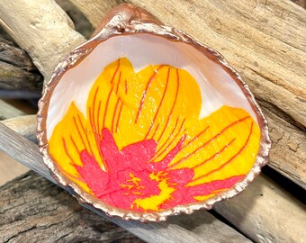 Decoupage yellow and pink Marimekko floral pattern on a real cockle shell, beach combed along Florida’s gulf coast.