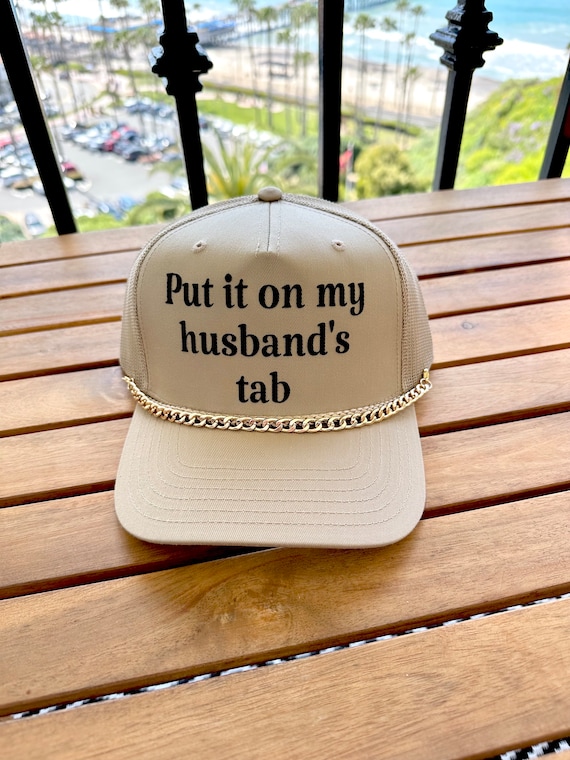 Put It On My Husbands Tab Trucker Hat Put It On My Husbands Tab Trucker Hat