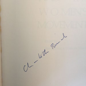 May include: A white page with blue ink handwriting that says "C - to the Bush"