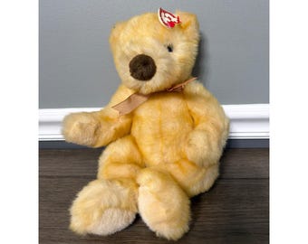 Oso de peluche vintage Ty Beanie Buddy Butterbeary de 1999 con cinta dorada en el cuello.
