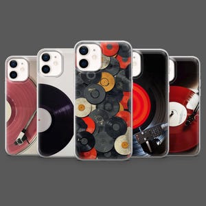 May include: A collection of five phone cases featuring vinyl record designs. The cases display various record colors, including red, black, and yellow, with some cases showing a turntable. The cases are on a gray background.