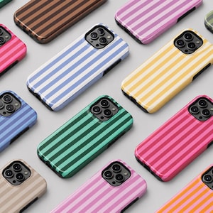 May include: A collection of smartphone cases arranged in a grid pattern, each featuring a distinct two-tone vertical striped design. The cases display various color combinations including pink, blue, yellow, green, orange, and beige, all with black camera cutouts.