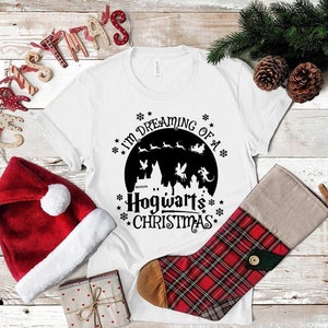 May include: White t-shirt with a black graphic of Hogwarts castle and the text "I'm dreaming of a Hogwarts Christmas".