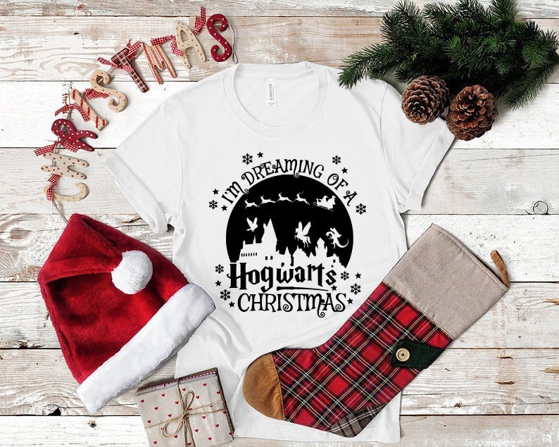 May include: White t-shirt with a black graphic of Hogwarts castle and the text "I'm dreaming of a Hogwarts Christmas".