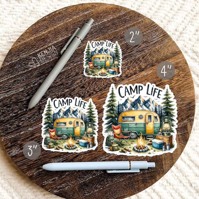 May include: Three vinyl stickers featuring a vintage camper van in a forest setting with the text "Camp Life". The stickers are available in 2 inch, 3 inch, and 4 inch sizes.