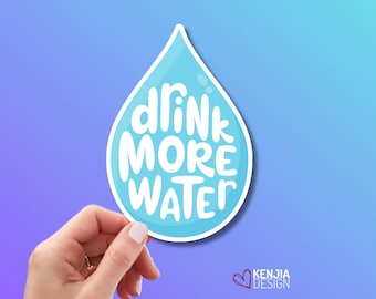 May include: A light blue water drop shaped sticker with a white border. The text "DRINK MORE WATER" is written in white, rounded, hand-lettered typography across the center of the drop. The sticker has a glossy finish and a small white highlight.
