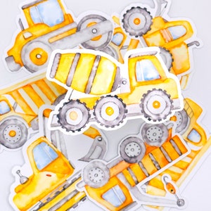 May include: Watercolor illustrations of construction vehicles, including a cement mixer, dump truck, and excavator. The stickers are primarily yellow, with gray and orange accents. The designs are on a white background.