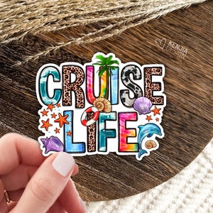 May include: A colorful sticker with the text "Cruise Life" in a rainbow tie-dye font. The sticker features a variety of beach-themed elements, including palm trees, seashells, starfish, and a dolphin.