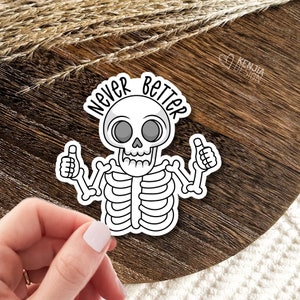 May include: A white skeleton with a big smile and thumbs up, with the text "Never Better" in a black outline.