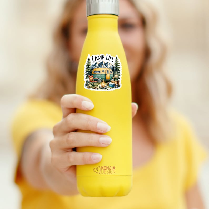 May include: Yellow reusable water bottle with a sticker that says "Camp Life" and depicts a vintage camper van in a forest setting.