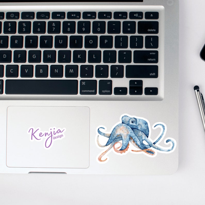 May include: A blue and orange watercolor octopus sticker with the text "Kenjia design" on a white background.