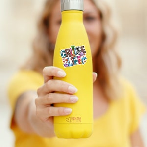 May include: Yellow stainless steel water bottle with a sticker that says "Cruise Life" with colorful beach-themed icons. The sticker has a white background and is surrounded by a black outline. The bottle has a black lid and a heart-shaped logo that says "Kenjia Design".