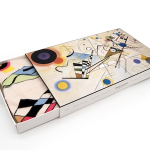 May include: A white box with a colorful abstract painting on the lid. The box is open and a white sock with a black, white, and red geometric pattern is inside. The painting is by Wassily Kandinsky and is titled "Composition VIII".